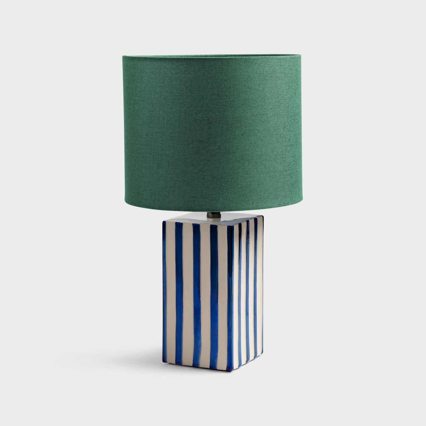 Lampada con base a strisce blu e cappello verde